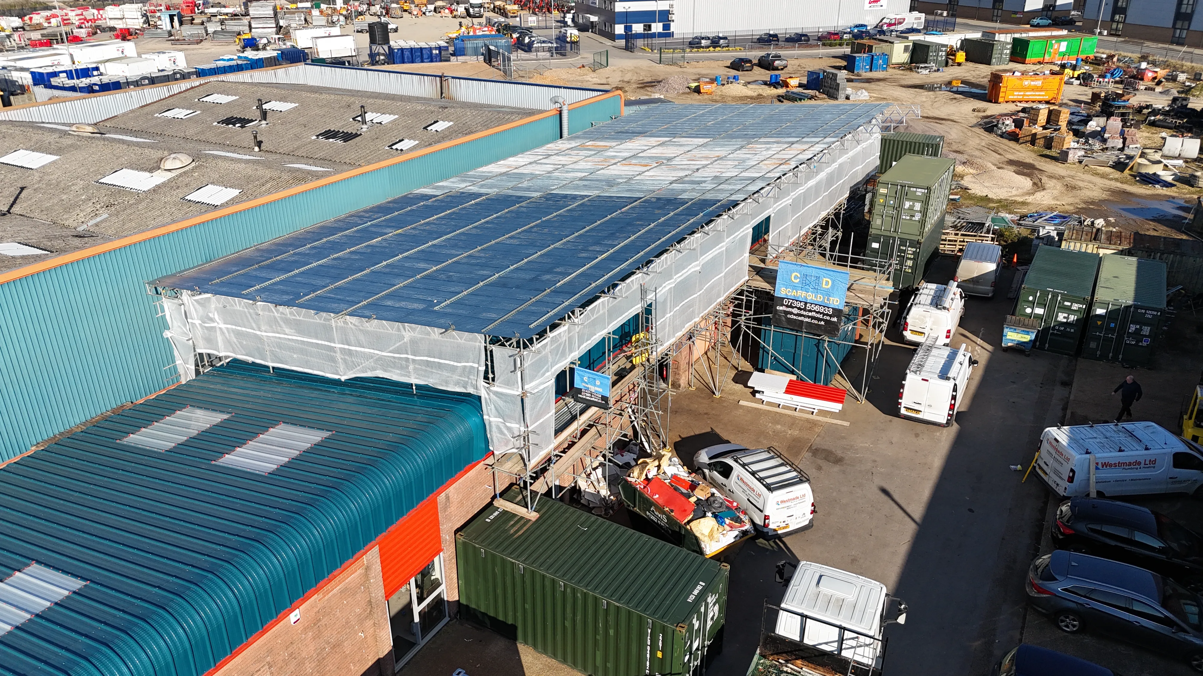 An aerial view of a building with a blue roof.